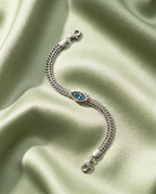 Firefly_GeminiFlash_14Silberfarbenes Armband mit blauem Anhänger 